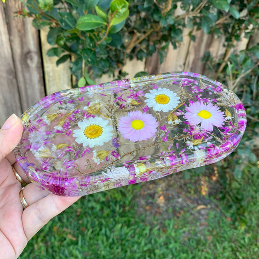 Clear resin tray with embedded flowers.