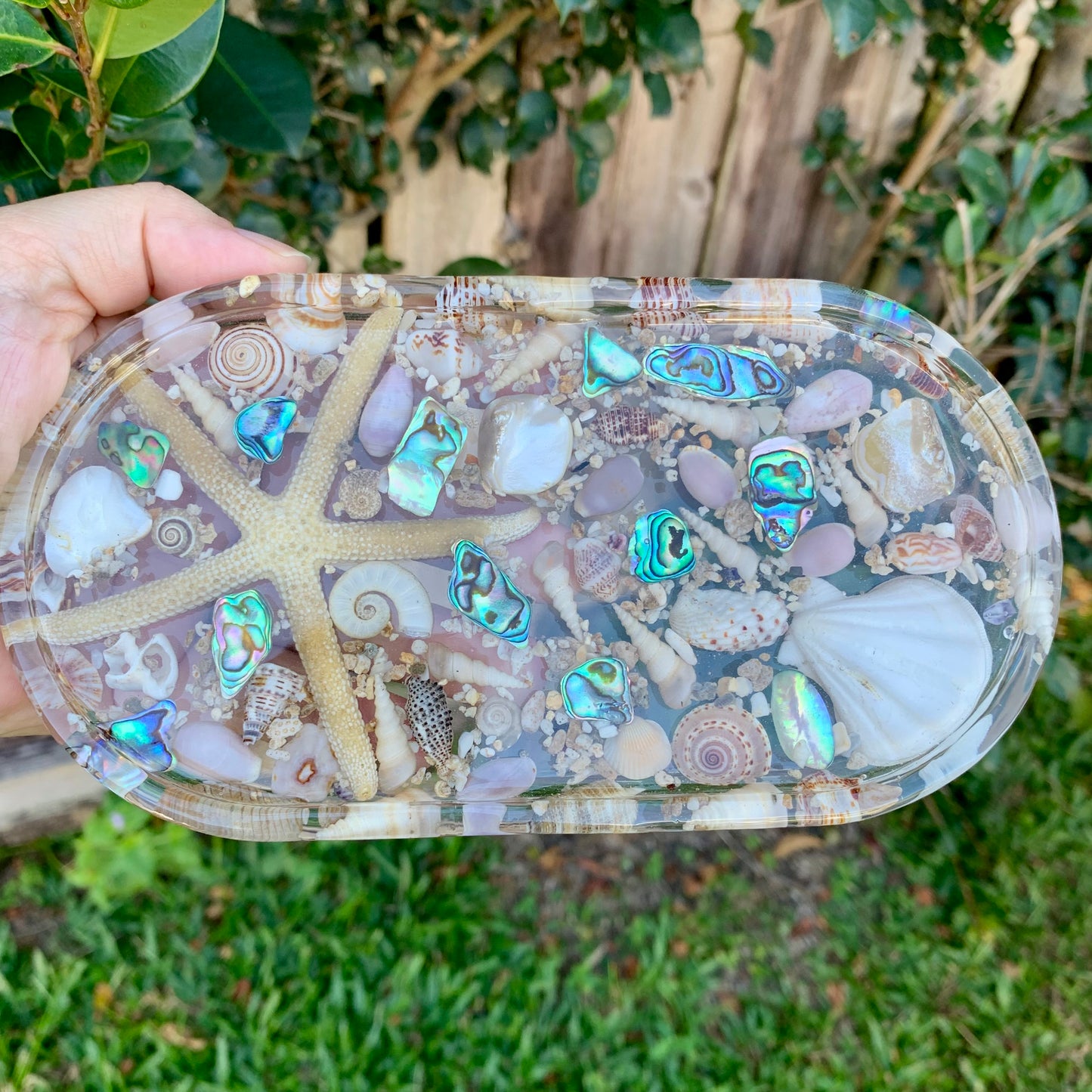 Decorative resin tray with seashells and starfish.