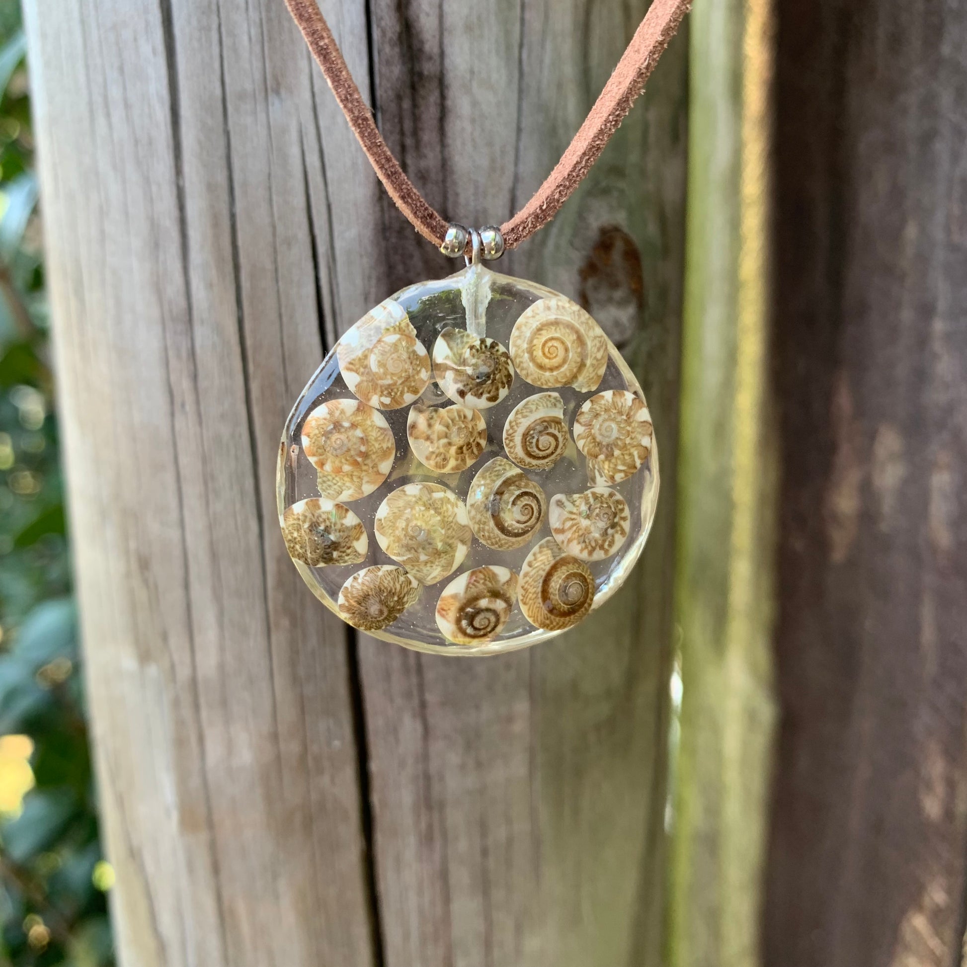 Shell necklace with brown spiral shells on a vegan suede cord