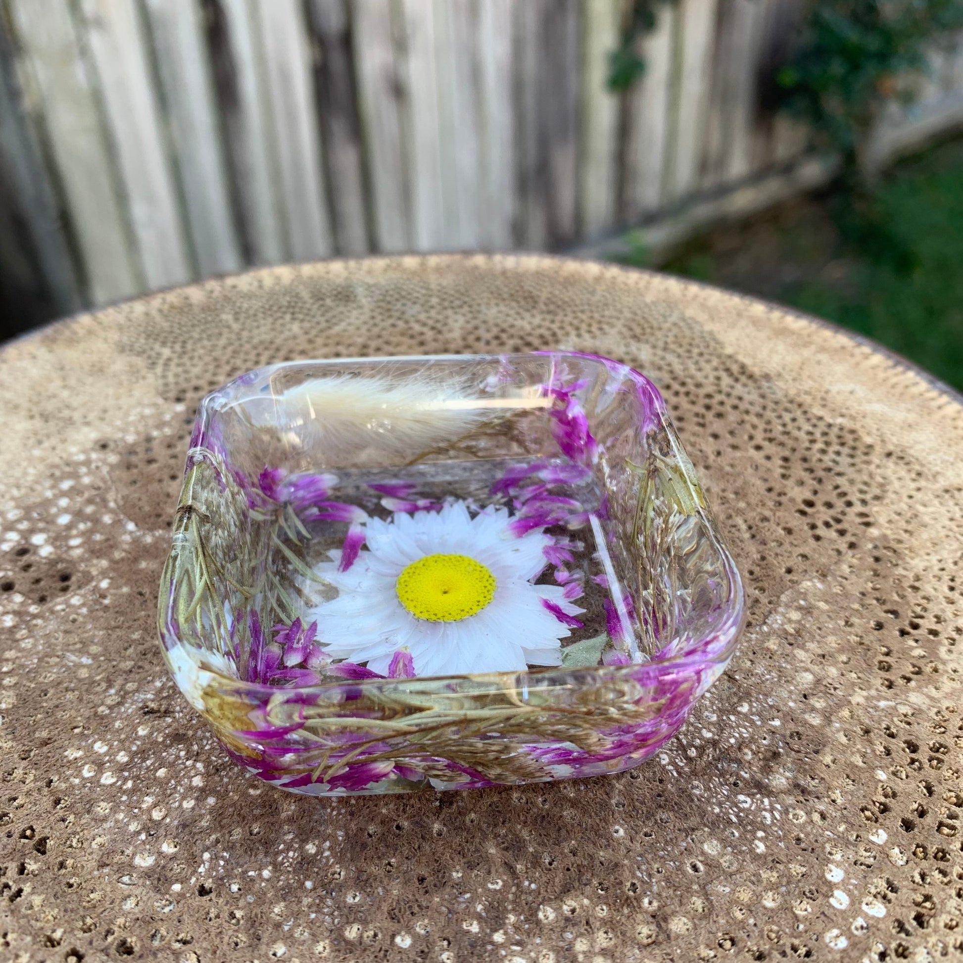 Decorative resin dish with flowers.