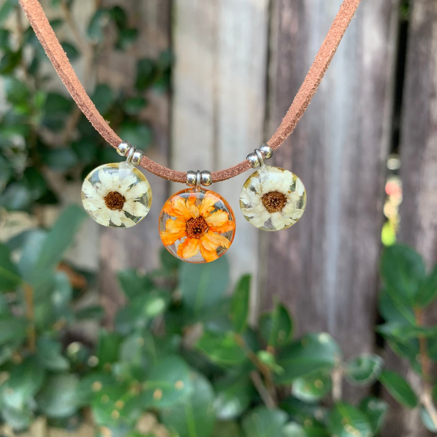 Orange and white Daisy flowers necklace on a brown suede vegan cord.