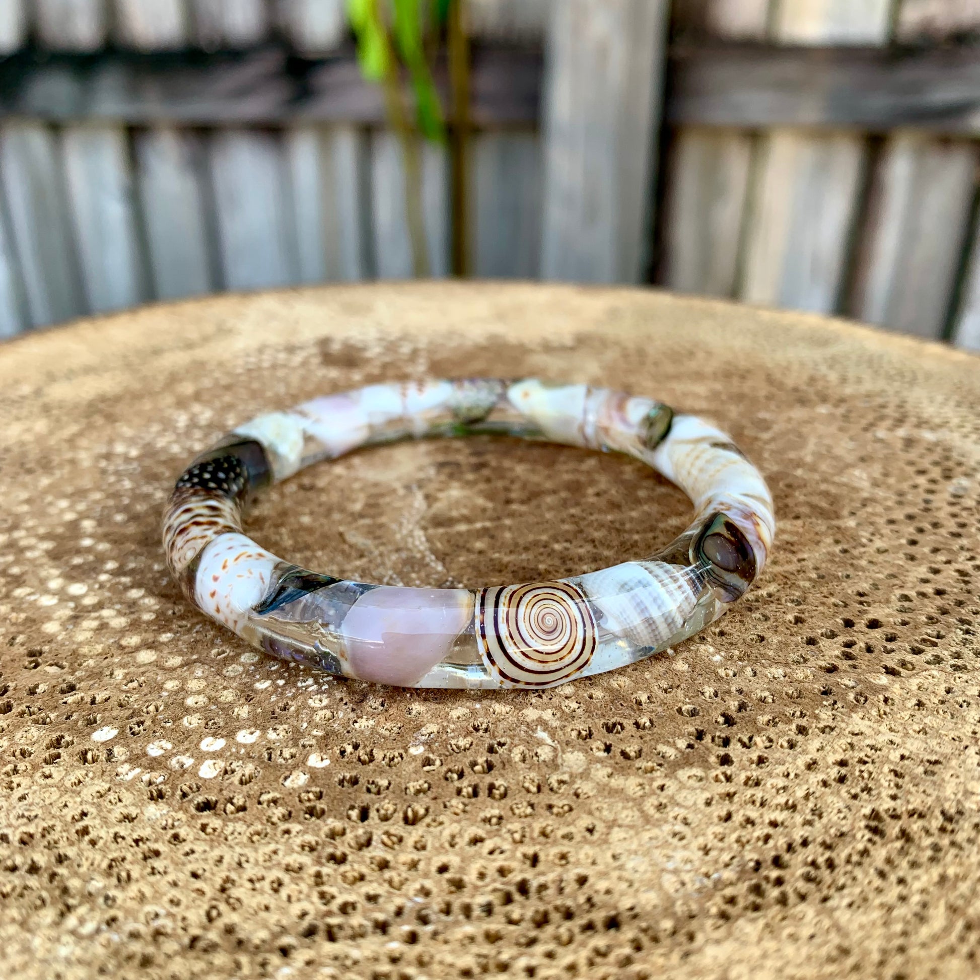 Seashell resin bangle featuring real sea shells and New Zealand paua shell.