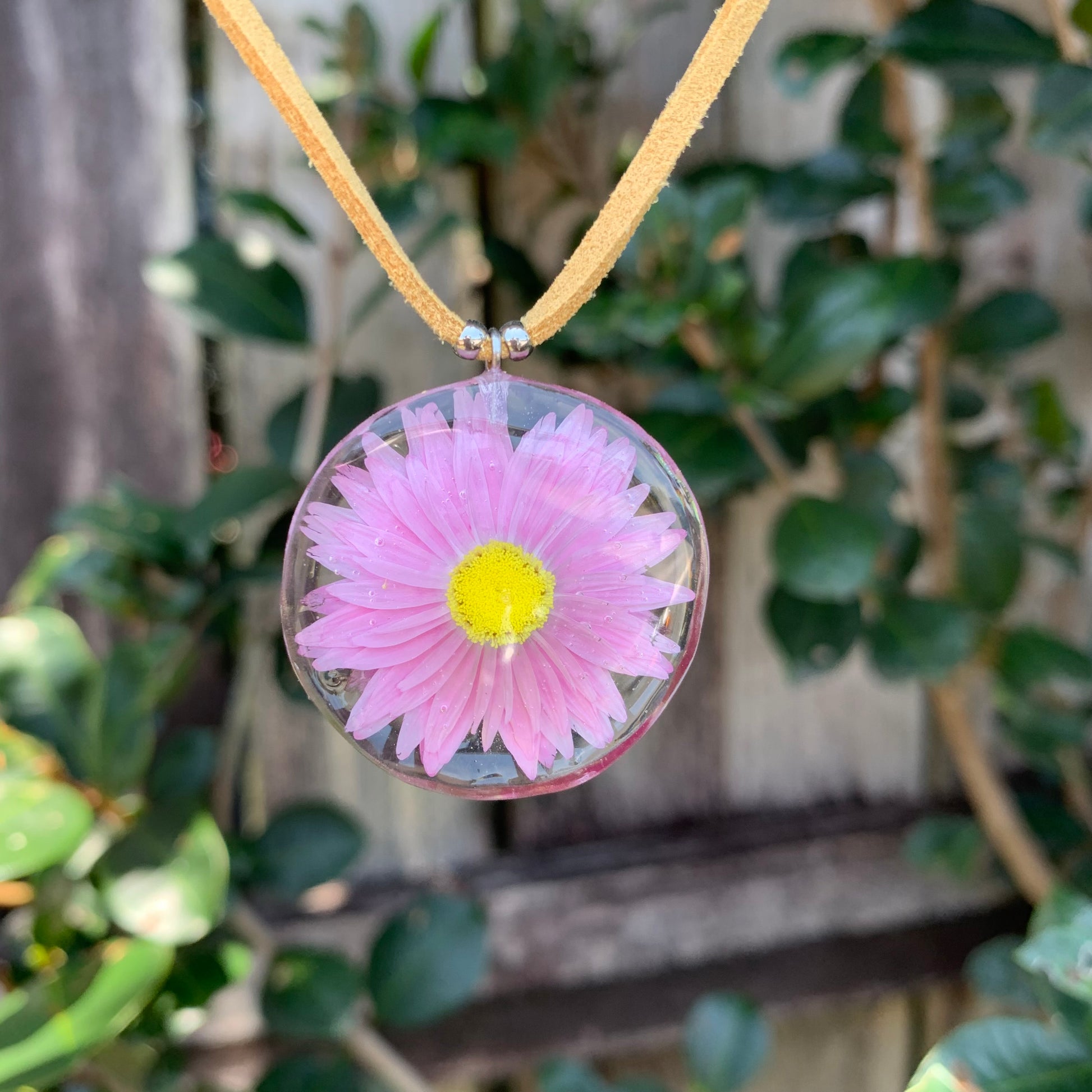 Necklace with a Pink Daisy pendant.