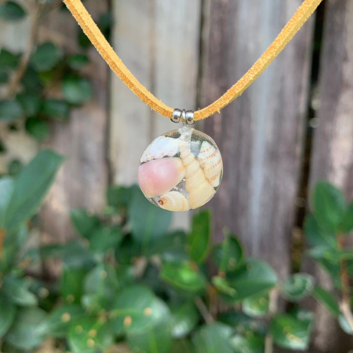 Necklace with seashells on a tan vegan suede cord