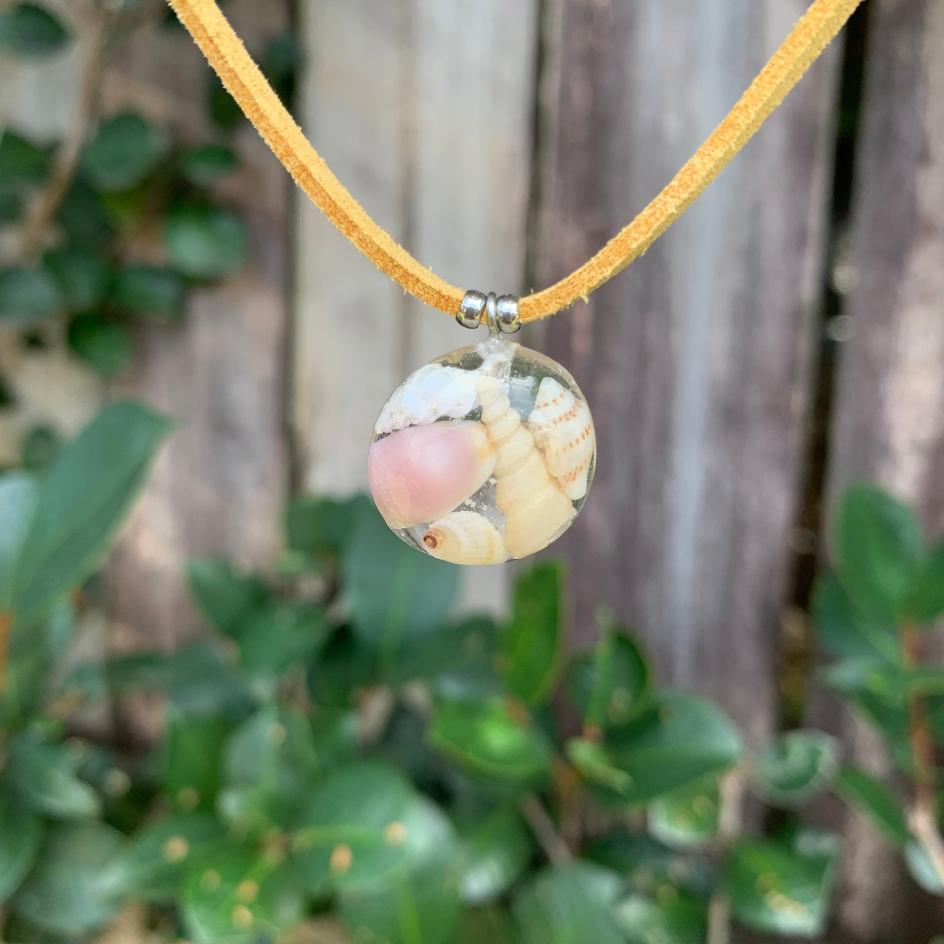 Necklace with seashells on a tan vegan suede cord