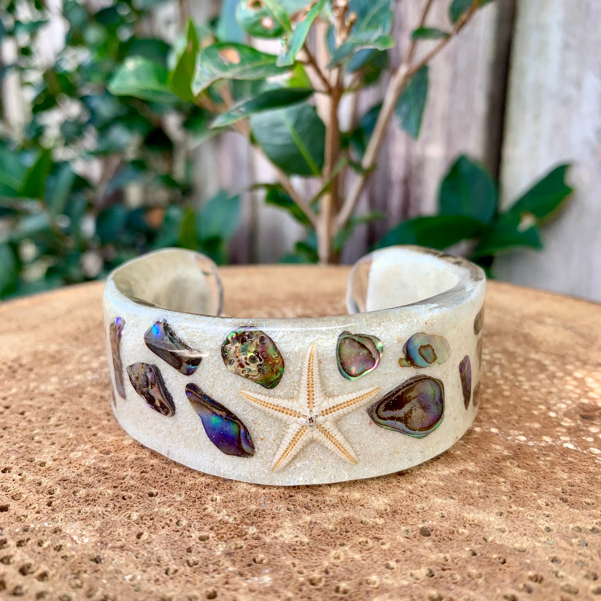 Resin cuff bangle with starfish snd paua shell. 