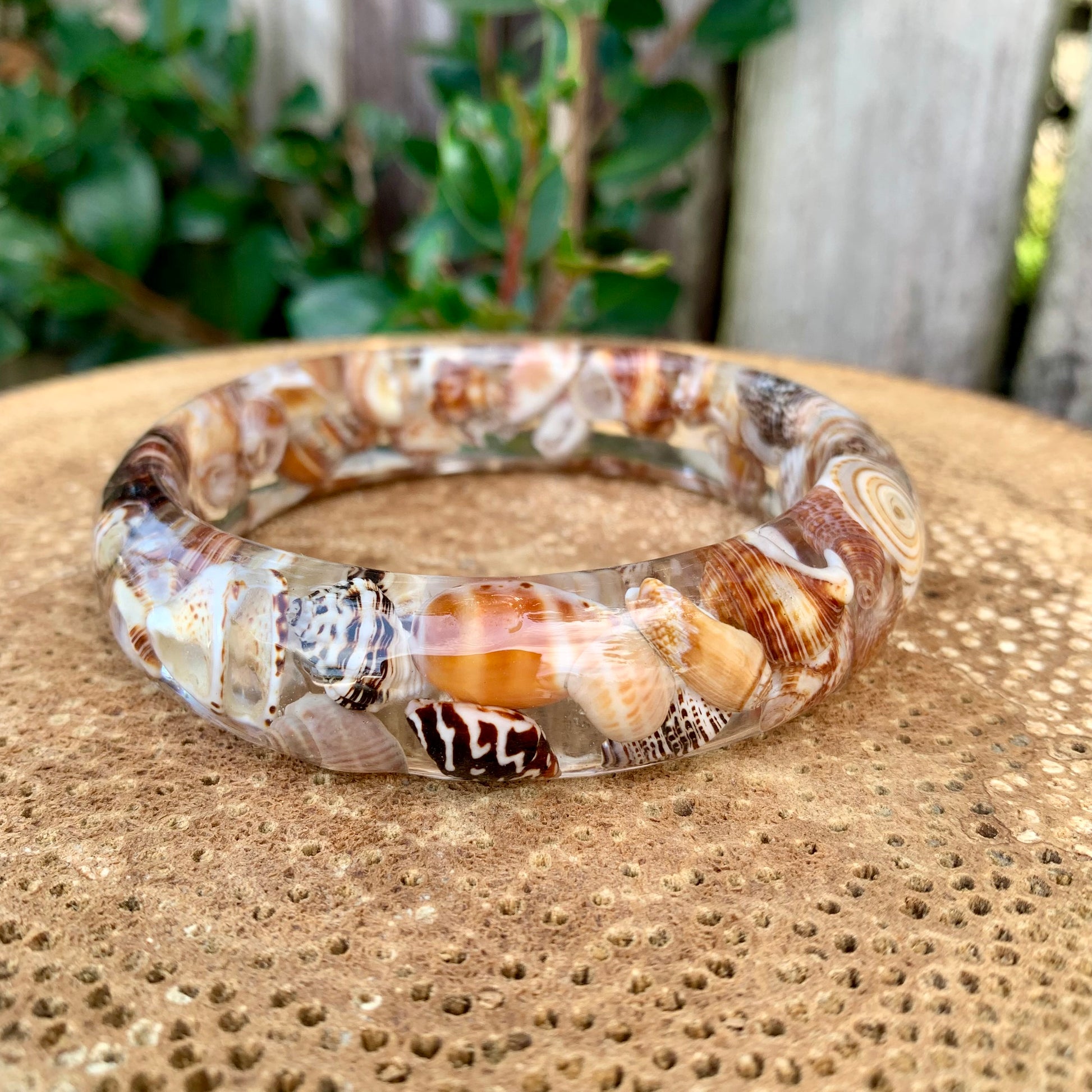 Seashell bangle made with resin and real brown seashells. 